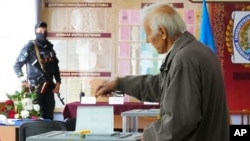 A man casts his ballot during a referendum in Luhansk, Luhansk People's Republic controlled by Russia-backed separatists, eastern Ukraine, Sept. 27, 2022.