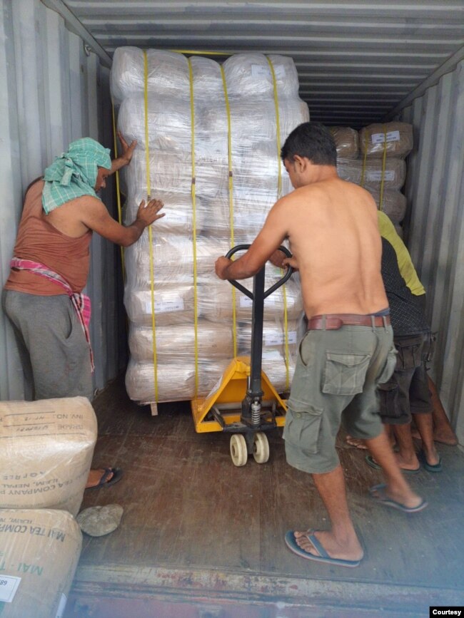 Workers load packed tea on to a truck to be exported, in the Ilam district of Nepal(Photo courtesy Kamal Raj Mainali)