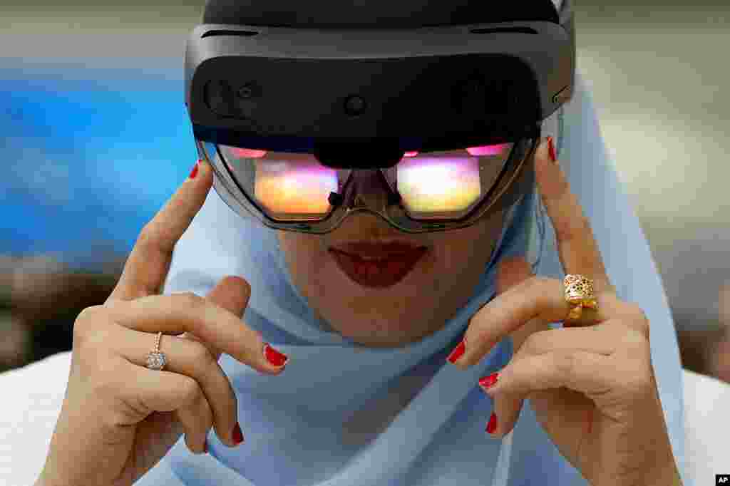 A women experiences VR virtual reality goggles during the Dubai Metaverse Assembly at the Emirates Towers, in Dubai, United Arab Emirates.