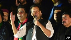 FILE - Pakistan's former Prime Minister Imran Khan, center, addresses during an anti-government rally in Islamabad, Pakistan, Aug. 20, 2022.