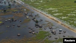 FILE: An aerial view shows flooded homes within a village after the River Nile broke the dykes in Jonglei State, South Sudan. Taken Oct. 5, 2020