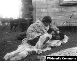 A Siberian Yupik woman skin stitching the face of a young woman, c. 1900. Photo by Russian ethnographer Vladimir Bogoras.