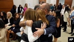 Victims' families embrace while waiting for a verdict in the penalty phase of the trial of Marjory Stoneman Douglas High School shooter Nikolas Cruz at the Broward County Courthouse in Fort Lauderdale, Florida, Oct. 13, 2022. (Amy Beth Bennett/South Florida Sun Sentinel via AP)