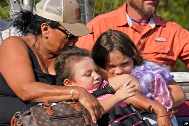 Yolanda Rios, left, holds her grandchildren Ava, 7, and Giovanni, 5, as as they are evacuated by airboat through floodwaters along the Peace River, to get to a hospital for medical care, in the aftermath of Hurricane Ian on Arcadia, Fla., Monday, Oct. 3, 2022. (AP Photo/Gerald Herbert, File)