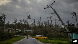 Utility poles tilt after being caught up by Hurricane Ian in Pinar del Rio, Cuba, Sept. 27, 2022.