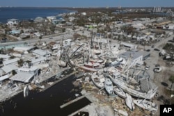 In this photo shot with a drone, shrimp boats lie grounded atop what was a mobile home park, following the passage of Hurricane Ian, on San Carlos Island in Fort Myers Beach, Fla., Oct. 7, 2022.