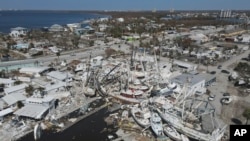 In this photo shot with a drone, shrimp boats lie grounded atop what was a mobile home park, following the passage of Hurricane Ian, on San Carlos Island in Fort Myers Beach, Fla., Oct. 7, 2022. 