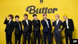 FILE- Members of South Korean K-pop band BTS, V, SUGA, JIN, Jung Kook, RM, Jimin, and j-hope from left to right, pose for photographers ahead of a press conference to introduce their new single "Butter" in Seoul, South Korea, May 21, 2021.