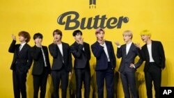 FILE- Members of South Korean K-pop band BTS, V, SUGA, JIN, Jung Kook, RM, Jimin, and j-hope from left to right, pose for photographers ahead of a press conference to introduce their new single "Butter" in Seoul, South Korea, May 21, 2021.