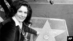 FILE - Country music singer Loretta Lynn points to her Hollywood Walk of Fame star during induction ceremonies in Hollywood, Calif., Feb. 8, 1978.