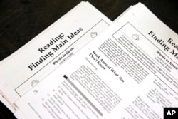 FILE - In this Jan. 17, 2016 file photo, students work sheets are seen at a college test preparation class at Holton Arms School in Bethesda, Md.