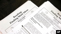 FILE - In this Jan. 17, 2016 file photo, students work sheets are seen at a college test preparation class at Holton Arms School in Bethesda, Md. (AP Photo/Alex Brandon, File)