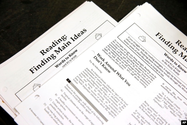 FILE - In this Jan. 17, 2016 file photo, students work sheets are seen at a college test preparation class at Holton Arms School in Bethesda, Md.