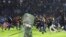 Soccer fans enter the pitch during a clash between supporters at Kanjuruhan Stadium in Malang, East Java, Indonesia, Oct. 1, 2022.