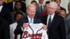 Atlanta Braves CEO Terry McGuirk watches as President Joe Biden regards the gift of a Braves jersey, Monday, Sept. 26, 2022, in Washington. 