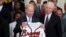 Atlanta Braves CEO Terry McGuirk watches as President Joe Biden regards the gift of a Braves jersey, Monday, Sept. 26, 2022, in Washington. 