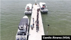 Imágenes de drone muestran a los migrantes abordando un bote en Necoclí, Colombia, con destino a Acandí, para luego adentrarse al Tapón del Darién y continuar su ruta hacia Estados Unidos, el 12 de octubre de 2022.