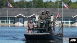 Osceola County Sheriffs use a fanboat as they urge residents to leave a flooded area following Hurricane Ian on Sept. 30, 2022 in Kissimmee, Florida.