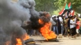 FILE: Sudanese protesters block a street in Omdourman the capital Khartoum's twin city on October 21, 2022. - Thousands of Sudanese took to the streets to renew protests nearly a year after a military coup derailed the country's transition to democracy.