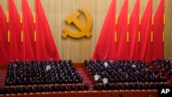 Attendees bow their heads to observe a moment of silence for fallen comrades during the opening ceremony of the 20th National Congress of China's ruling Communist Party held at the Great Hall of the People in Beijing, China, Oct. 16, 2022.
