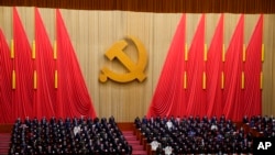 Attendees bow their heads to observe a moment of silence for fallen comrades during the opening ceremony of the 20th National Congress of China's ruling Communist Party held at the Great Hall of the People in Beijing, China, Oct. 16, 2022.