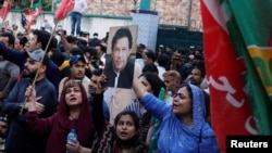 Supporters of Pakistan's Tehreek-e-Insaf (PTI) political party chant slogans as they gather, after the country's Election Commission disqualified former Prime Minister Imran Khan from running for political office, during a protest in Karachi, Oct. 21, 2022.