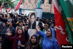 FILE - Supporters of Pakistan's Tehreek-e-Insaf (PTI) political party chant slogans as they gather, after the country's Election Commission disqualified former Prime Minister Imran Khan from running for political office, during a protest in Karachi, Oct. 21, 2022.