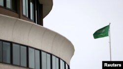 FILE - The flag of Saudi Arabia flies above the Saudi Arabia embassy near the Watergate Complex in Washington, Feb. 26, 2021. 