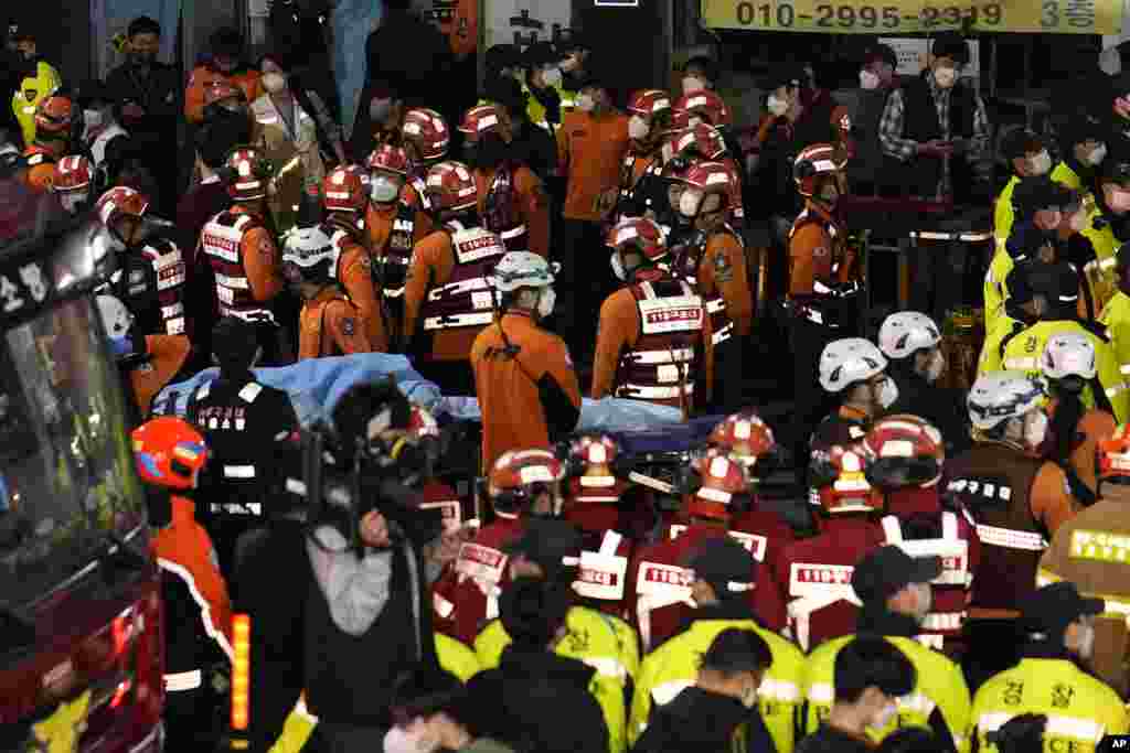 Rescue workers, firefighters and police officers are seen on the street near the scene in Seoul, South Korea, Oct. 30, 2022. 