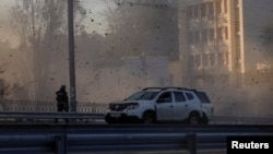 A view shows flying debris from an explosion in a street during a Russian drone strike, which local authorities consider to be Iranian-made Shahed-136 unmanned aerial vehicles (UAVs), in Kyiv, Ukraine, Oct. 17, 2022. 