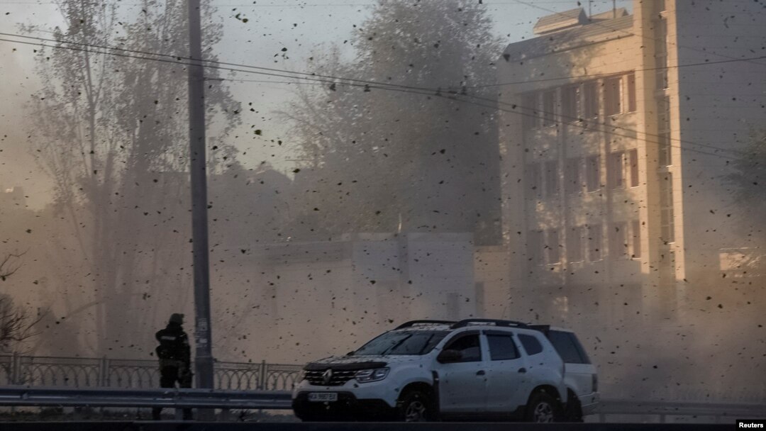 FILE - A view shows flying debris from an explosion in a street during a Russian drone strike, which local authorities consider to be Iranian-made Shahed-136 unmanned aerial vehicles (UAVs), in Kyiv, Ukraine, Oct. 17, 2022. 