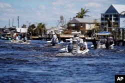 Boats operated by residents help evacuate residents who stayed behind on Pine Island, in the aftermath of Hurricane Ian in Matlacha Fla., Sunday, Oct. 2, 2022. (AP Photo/Gerald Herbert, File)