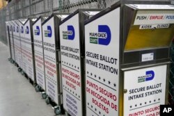 FILE - Ballot boxes are lined up as employees test voting equipment at the Miami-Dade County Elections Department, in Miami, Oct. 19, 2022.