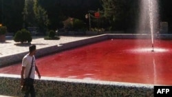 A man walk past the fountain of Park Daneshjoo, or Student Park, in the Iranian capital Tehran, reportedly colored red in protest against a deadly crackdown on three weeks of protests sparked by the death in custody of Mahsa Amini, in this UGC image made available on Twitter on Oct. 7, 2022.