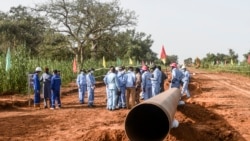FILE—Workers from Niger and China are seen on the construction site of an oil pipeline in the region of Gaya, Niger, on October 10, 2022. 