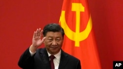 FILE - Chinese President Xi Jinping waves at the Great Hall of the People in Beijing on Oct. 23, 2022. After he was named to another term as head of the ruling Communist Party, Xi strengthened his grip on China's military command.