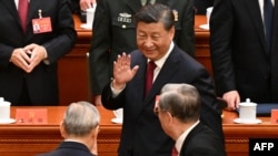 China's President Xi Jinping, center, waves as he leaves after the opening session of the 20th Chinese Communist Party's Congress at the Great Hall of the People in Beijing on Oct. 16, 2022. 