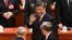 China's President Xi Jinping, center, waves as he leaves after the opening session of the 20th Chinese Communist Party's Congress at the Great Hall of the People in Beijing on Oct. 16, 2022. 