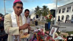 FILE - East Timor's Roman Catholic Bishop and Nobel Prize laureate Carlos Ximenes Belo prays in a ceremony to pay last respects to the former head of the UN Transition Authority in East Timor, Sergio Vieira De Mello in Dili, on Aug. 23, 2003.