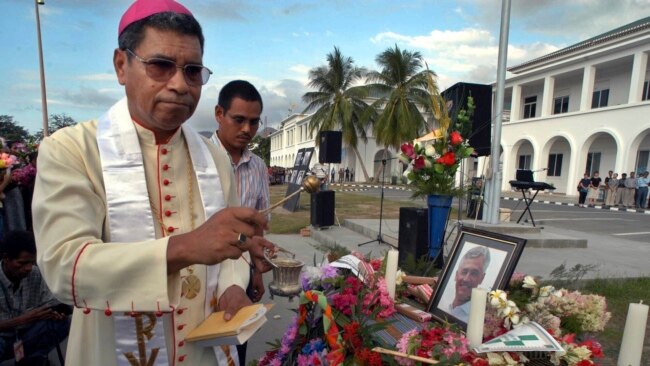 FILE - East Timor's Roman Catholic Bishop and Nobel Prize laureate Carlos Ximenes Belo prays in a ceremony to pay last respects to the former head of the UN Transition Authority in East Timor, Sergio Vieira De Mello in Dili, on Aug. 23, 2003.