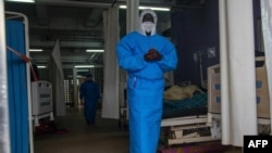 A member of the Ugandan Medical staff of the Ebola Treatment Unit stands inside the ward at Mubende Regional Referral Hospital in Uganda, Sept. 24, 2022. 