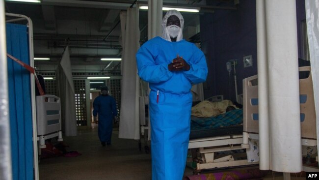 A member of the Ugandan Medical staff of the Ebola Treatment Unit stands inside the ward at Mubende Regional Referral Hospital in Uganda, Sept. 24, 2022.