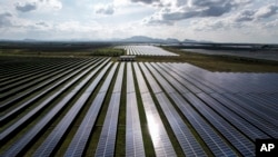 A solar plant sits in Pavagada Tumkur district, in the southern Indian state of Karnataka, India, Sept. 15, 2022. India is investing heavily in renewable energy and has committed to producing 50% of its power from clean energy sources by 2030.