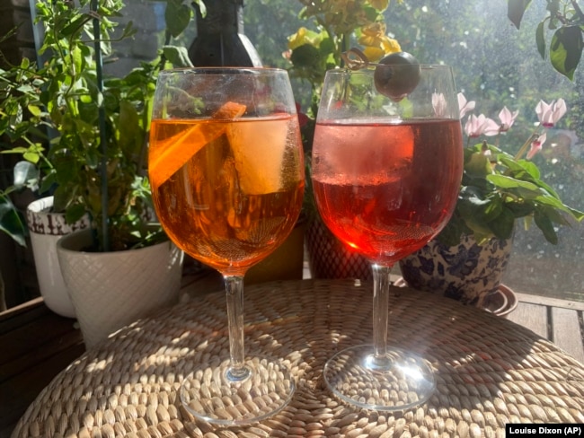 Venetian Spritz is wine-based cocktail. Its modern form consists of prosecco, digestive bitters and soda water. Pictured here is an Aperol Spritz, left, and Select Spritz. (AP Photo/Louise Dixon)