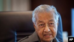 FILE - Malaysia's former Prime Minister Mahathir Mohamad speaks during an interview with The Associated Press at his office in Kuala Lumpur, Malaysia, Friday, Aug. 19, 2022.