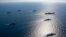 US aircraft carrier USS Ronald Reagan, top right, participates with other US and South Korean navy ships during the joint naval exercises between the United States and South Korea in waters off South Korea's eastern coast in South Korea, on Sept. 29, 2022