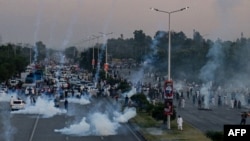 Police use teargas to disperse supporters of Pakistan's Tehreek-e-Insaf party (PTI) rallying against the decision to disqualify former Prime Minister Imran Khan from running for political office, in Islamabad, Oct. 21, 2022.