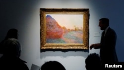 FILE - The painting by Claude Monet, part of the Haystacks 'Les Meules' series is displayed at Sotheby's in New York, U.S., May 3, 2019.