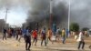 Anti-government demonstrators set a barricade on fire during clashes in N'Djamena, Chad, Oct. 20, 2022.