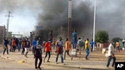 FILE: Anti-government demonstrators set a barricade on fire during clashes in N'Djamena, Chad, Oct. 20, 2022.